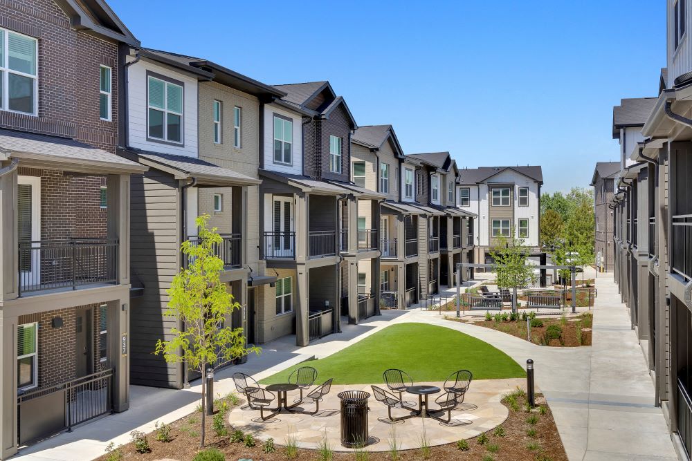 View of the courtyard with outdoor seating, grill and townhomes around